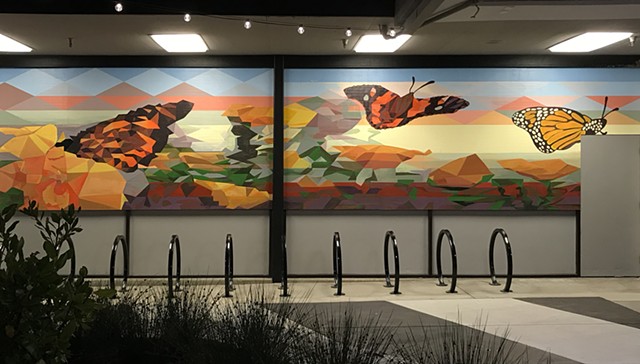 a mural of butterflies and bicycle racks