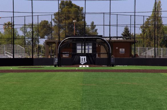 a baseball field with a black gate