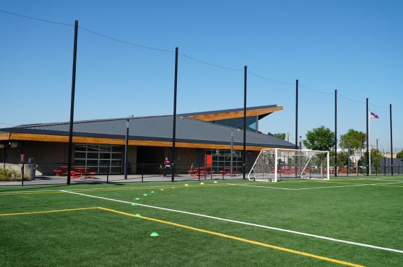 a football field with a building and a football goal