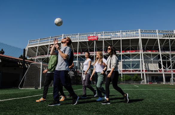 a group of people on a field with a football ball