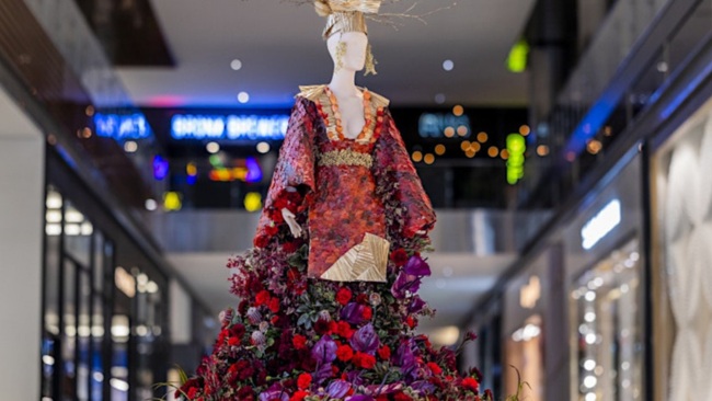 a mannequin wearing a dress made of flowers