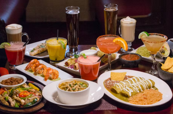 a table with plates of food and drinks