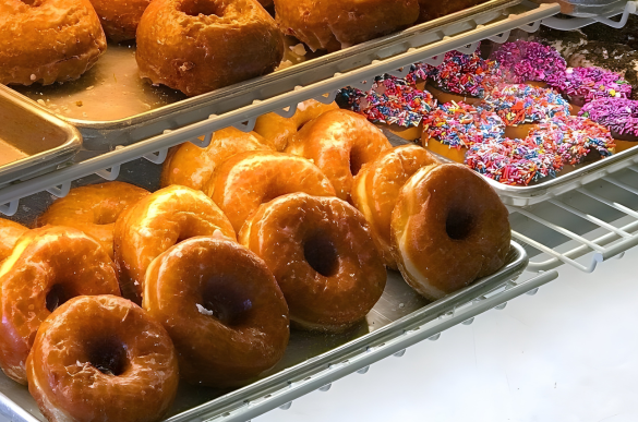 a tray of doughnuts on a shelf