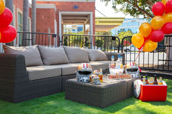 a couch with football helmets and balloons on it